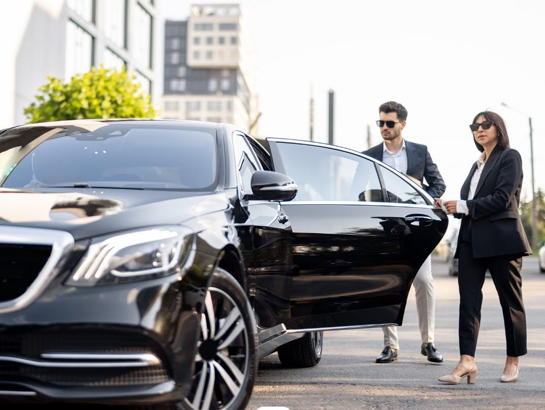 black car with passenger opening the door