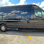 Driver behind the wheel of a Mercedes Sprinter van