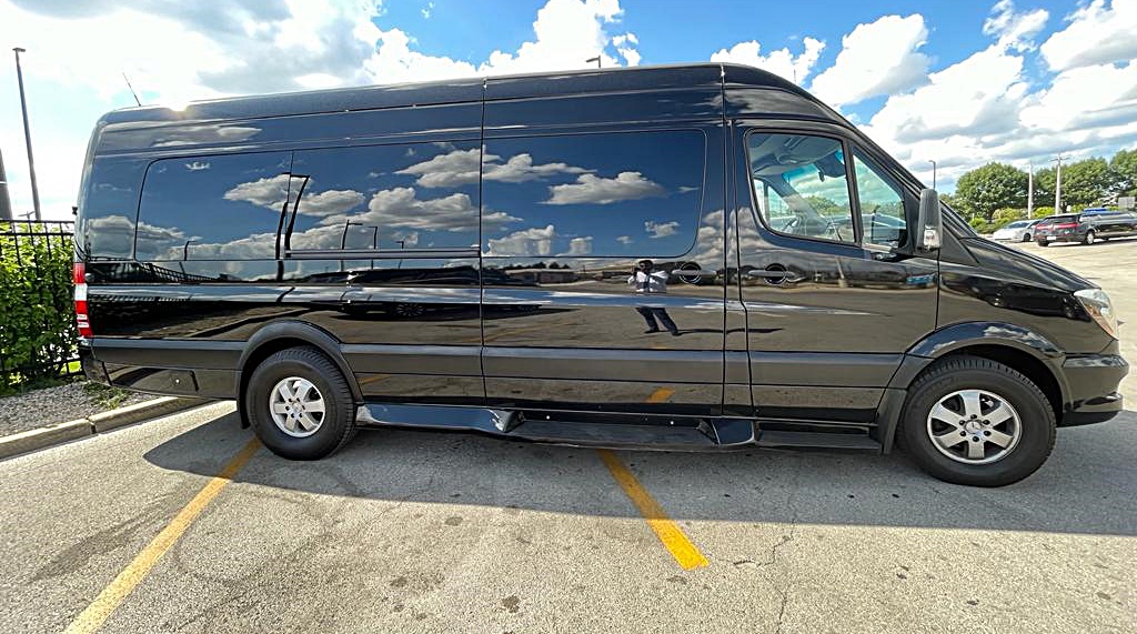 Driver behind the wheel of a Mercedes Sprinter van