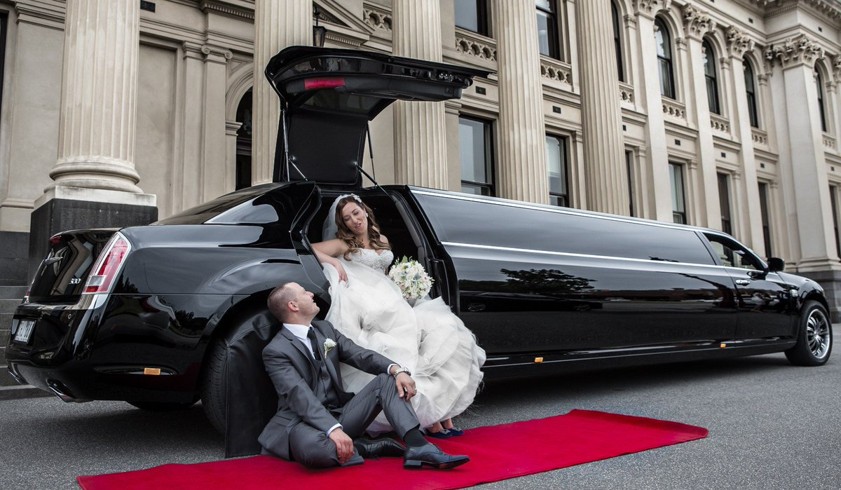 Elegant executive limo parked outside a venue, ideal for luxurious NYC wedding transportation